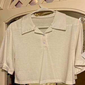 Collared white shirt that goes great with high jeans, or under a crew neck!